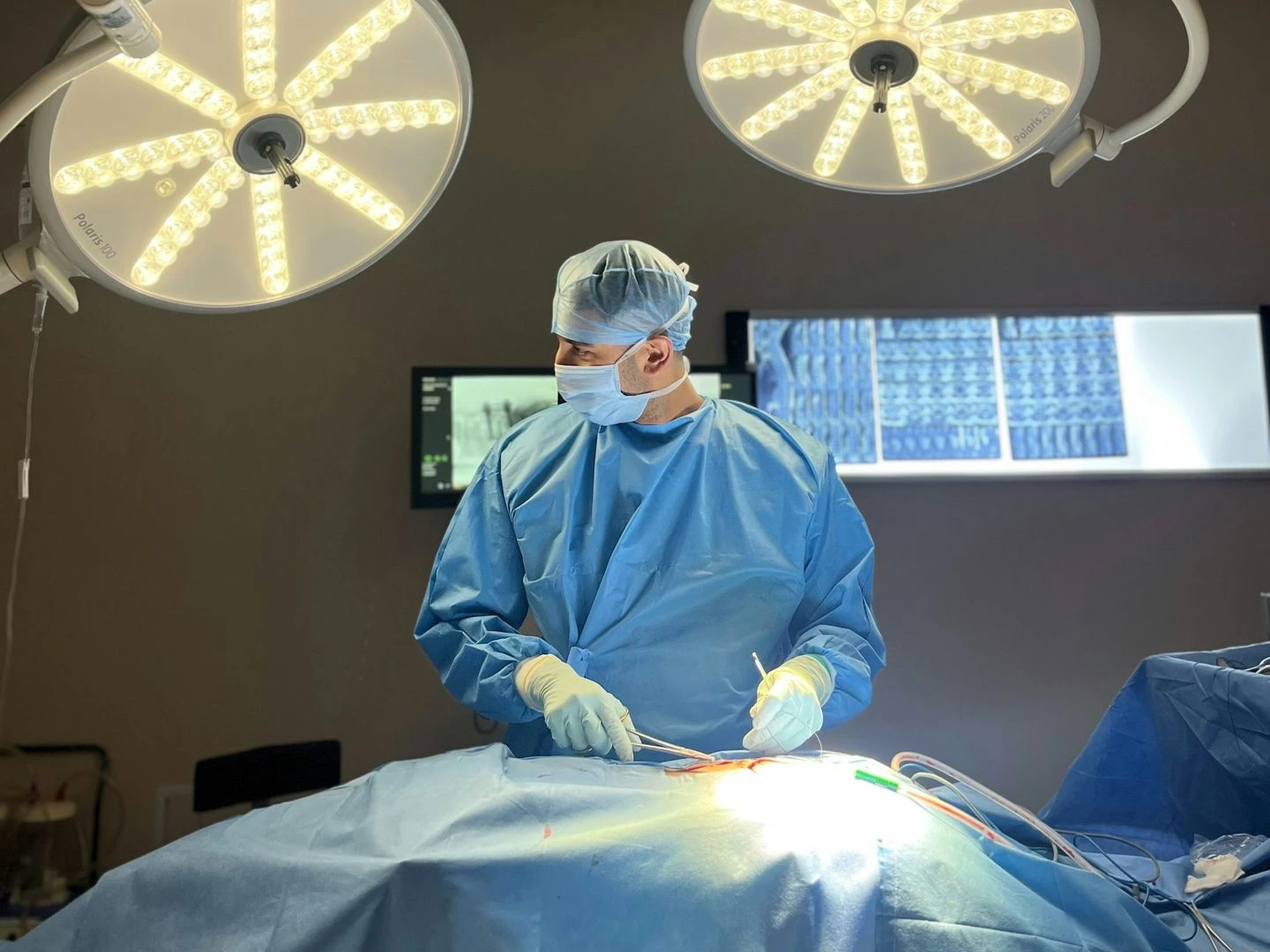 A surgeon is operating on a patient in the operating room